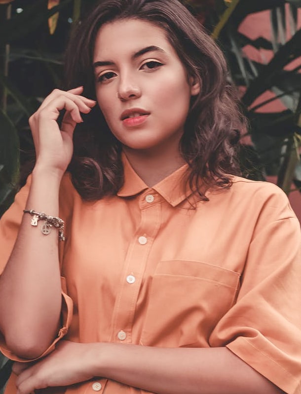 Woman in front of plant