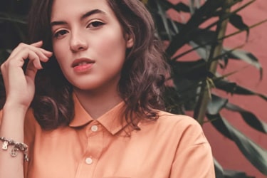 Woman in front of plant